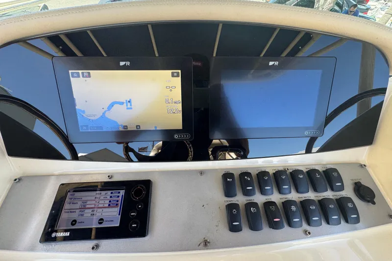 Slide: The Image of Dashboard of a 2015 Chris-Craft Catalina 26 with navigation and control panels. - 10