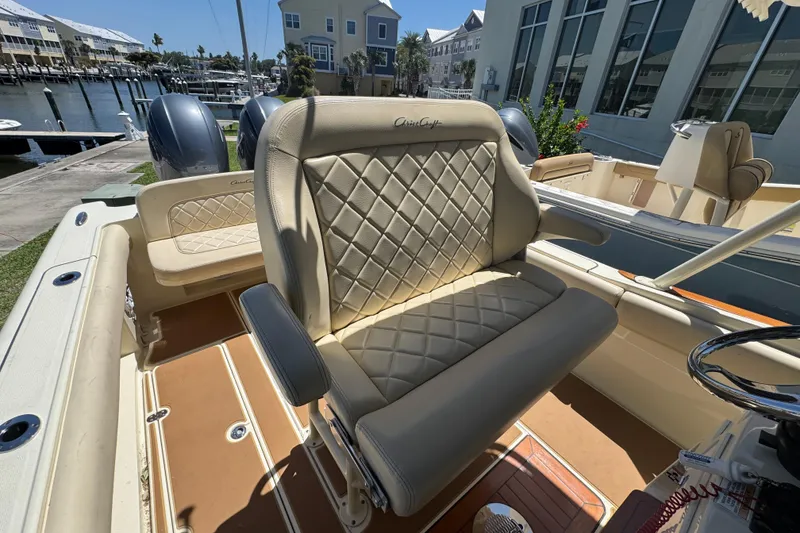 Slide: The Image of 2015 Chris-Craft Catalina 26 boat interior with luxurious diamond-stitched seating and dual engines. - 13