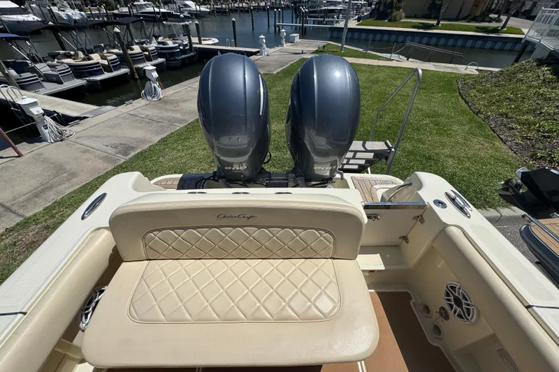 Slide: The Image of 2015 Chris-Craft Catalina 26 boat with dual engines docked at a marina. - 17