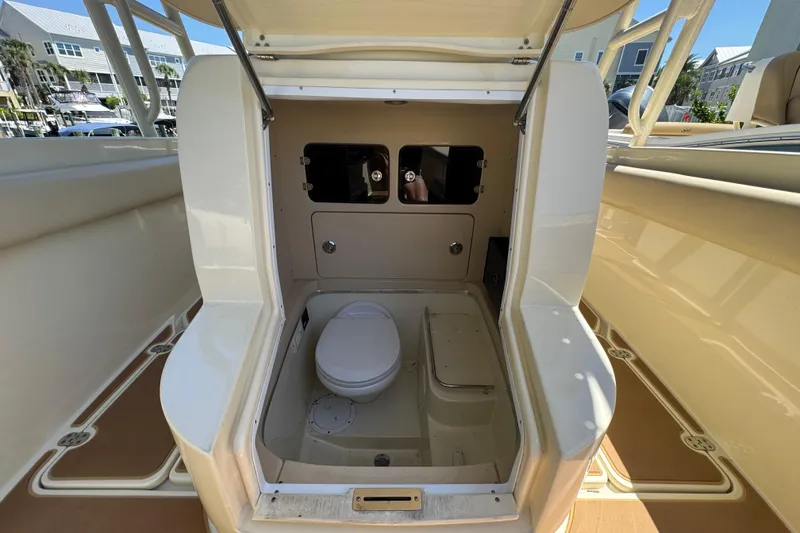 Slide: The Image of 2015 Chris-Craft Catalina 26 boat interior with compact marine toilet and storage area. - 18