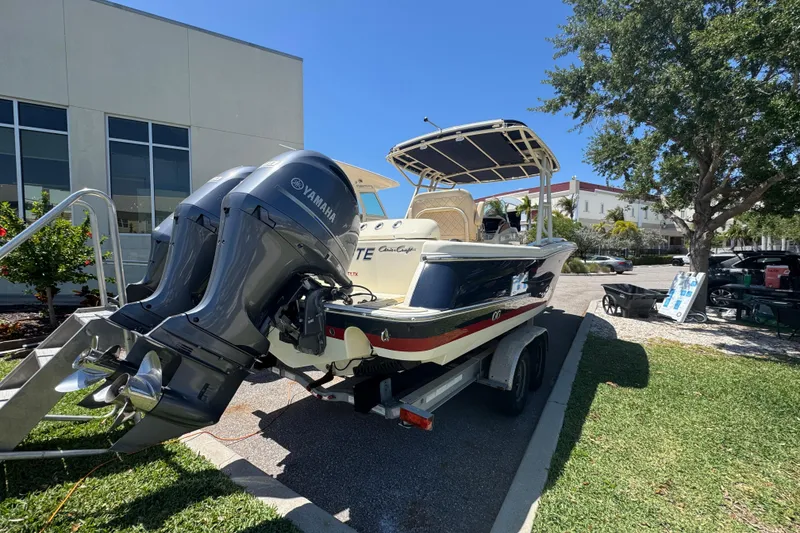 Slide: The Image of 2015 Chris-Craft Catalina 26 boat with Yamaha engines on a trailer, parked outdoors. - 3