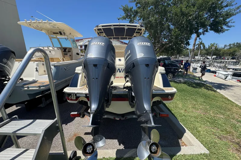Slide: The Image of 2015 Chris-Craft Catalina 26 with dual Yamaha 200 engines, docked outdoors. - 4
