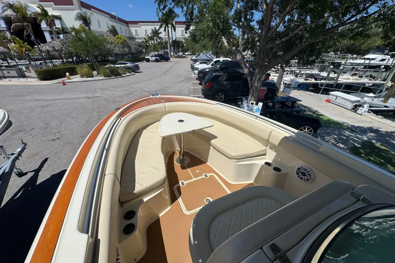 Slide: The Image of 2015 Chris-Craft Catalina 26 boat interior with seating and table, parked near marina. - 5