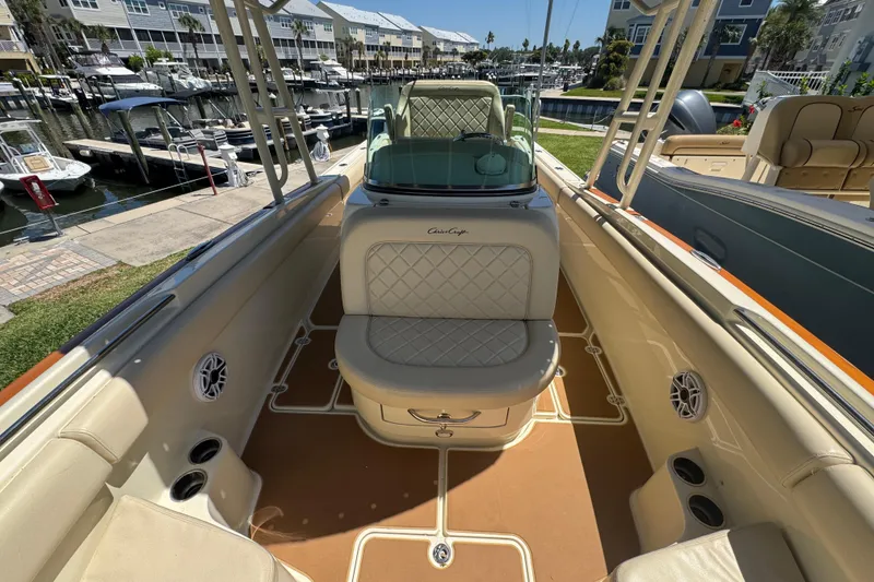 Slide: The Image of 2015 Chris-Craft Catalina 26 boat interior with beige seating and marina view. - 6