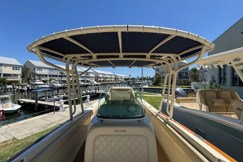 Slide: The Image of 2015 Chris-Craft Catalina 26 boat docked at a marina under clear blue skies. - 7