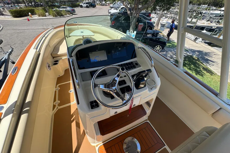 Slide: The Image of 2015 Chris-Craft Catalina 26 boat interior with steering wheel and navigation system. - 9