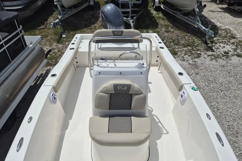Slide: The Image of 2026 Key West 179 FS boat interior with seating and steering console. - 14