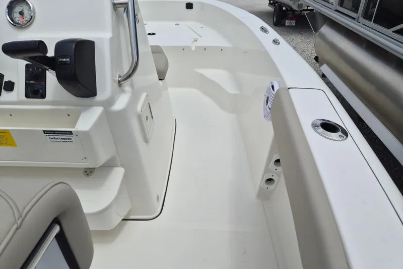 Slide: The Image of 2026 Key West 179 FS boat interior with steering console and seating area. - 6