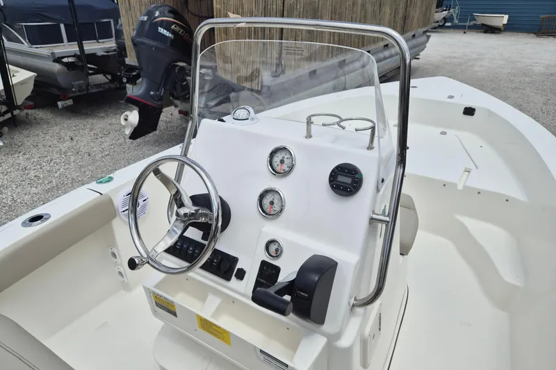 Slide: The Image of 2026 Key West 179 FS boat console with steering wheel and gauges. - 7