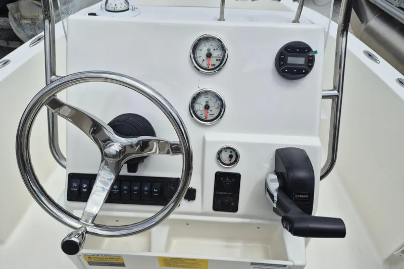 Slide: The Image of Steering console of 2026 Key West 179 FS boat with gauges and controls. - 8