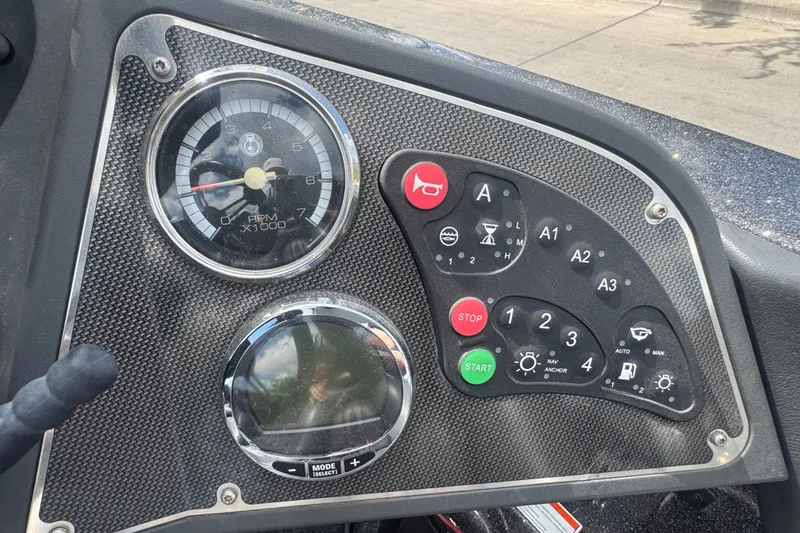Slide: The Image of Dashboard of a 2010 Ranger Z521 Comanche boat with gauges and control buttons. - 12