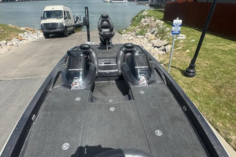Slide: The Image of 2010 Ranger Z521 Comanche boat at a lakeside ramp with a van nearby. - 9