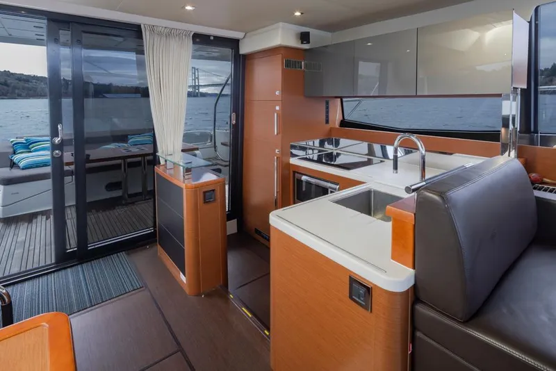 Slide: The Image of Interior of 2017 Prestige 560 yacht with modern kitchen and scenic water view. - 12