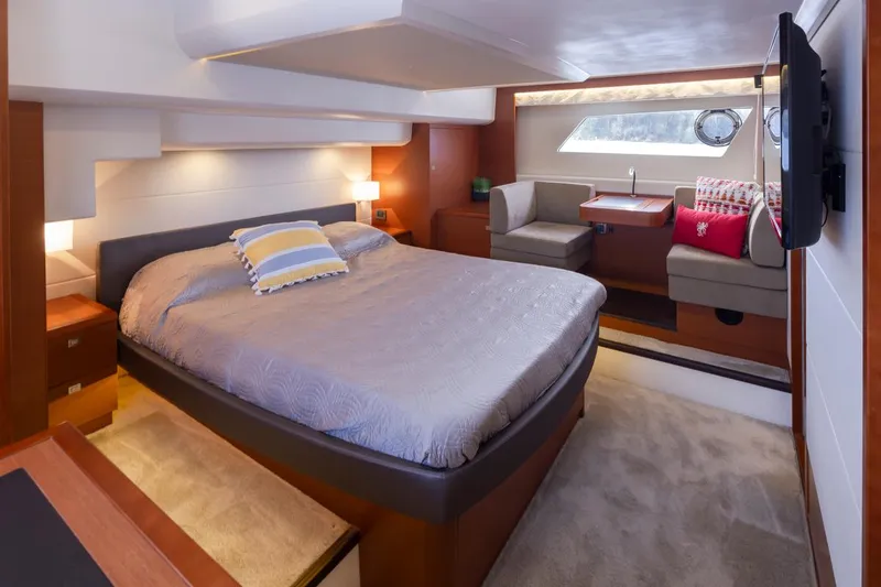 Slide: The Image of Luxurious bedroom interior of 2017 Prestige 560 yacht with cozy bed and seating area. - 21