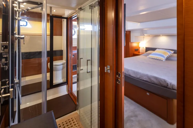 Slide: The Image of Luxurious interior of 2017 Prestige 560 yacht featuring bedroom and bathroom. - 29