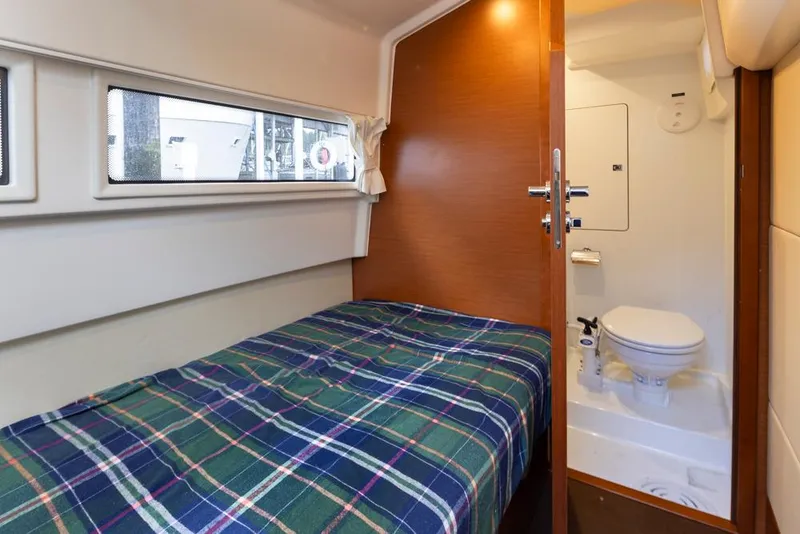 Slide: The Image of 2017 Prestige 560 yacht cabin with bed and compact bathroom. - 42