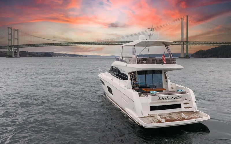 Slide: The Image of Prestige 560 yacht cruising under a bridge at sunset, 2017 model. - 5