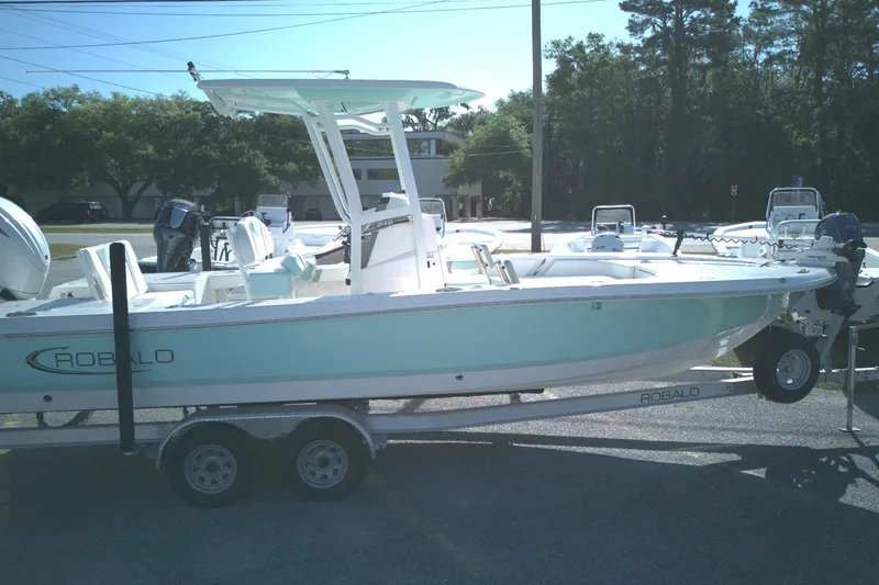 The Image of 2024 Robalo 246 Cayman boat on trailer, parked outdoors. - 0