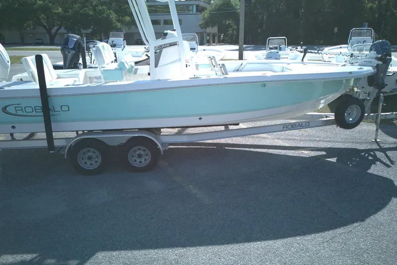 Slide: The Image of 2024 Robalo 246 Cayman boat on trailer in parking lot, side view. - 11