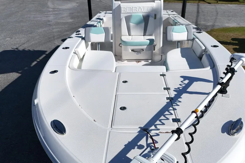 Slide: The Image of 2024 Robalo 246 Cayman boat deck with seating and fishing equipment. - 12