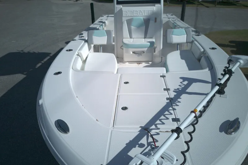 Slide: The Image of 2024 Robalo 246 Cayman boat deck with seating and fishing equipment. - 5