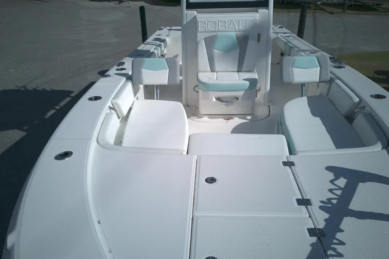 Slide: The Image of 2024 Robalo 246 Cayman boat interior with white and teal seating. - 6
