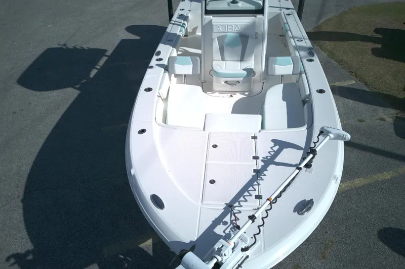 Slide: The Image of 2024 Robalo 246 Cayman boat, white deck, spacious seating, and modern design. - 9