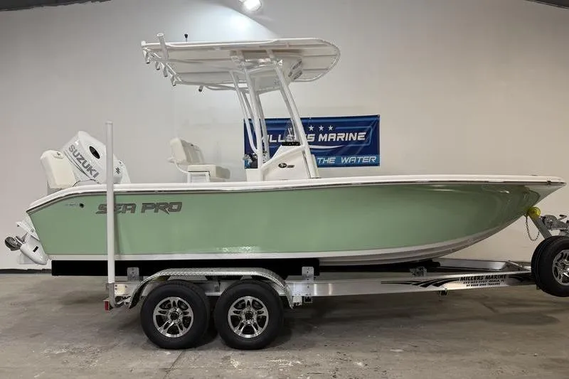 The Image of 2026 Sea Pro 202 Center Console boat on trailer in showroom. - 0