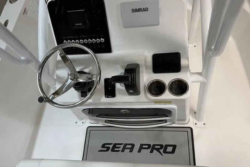 Slide: The Image of 2026 Sea Pro 202 Center Console dashboard with steering wheel and Simrad electronics. - 11