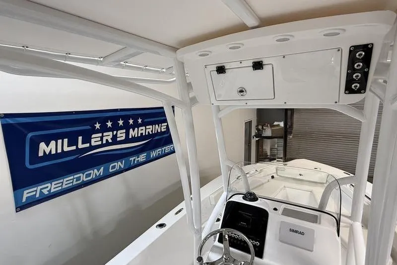 Slide: The Image of 2026 Sea Pro 202 Center Console boat interior at Miller's Marine showroom. - 12