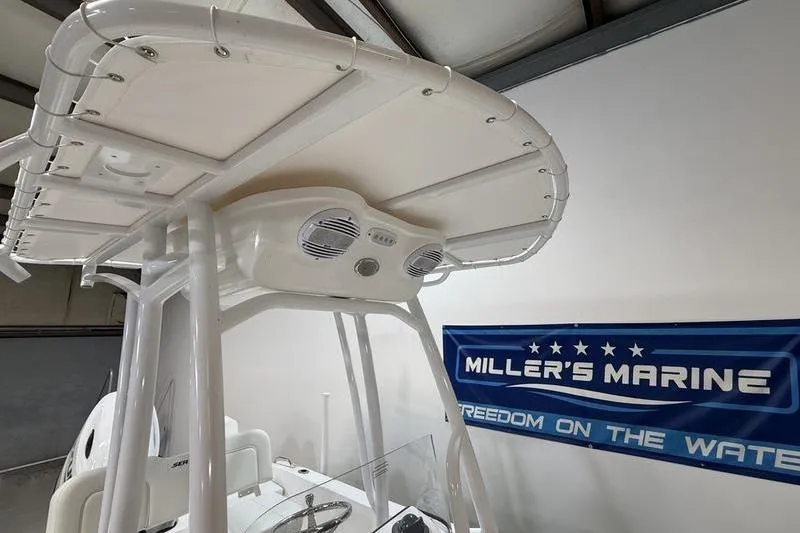 Slide: The Image of 2026 Sea Pro 202 Center Console boat with T-top and speakers at Miller's Marine. - 13