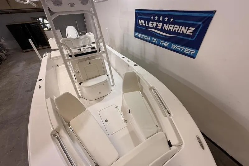 Slide: The Image of 2026 Sea Pro 202 Center Console boat in showroom, featuring spacious seating and modern design. - 14