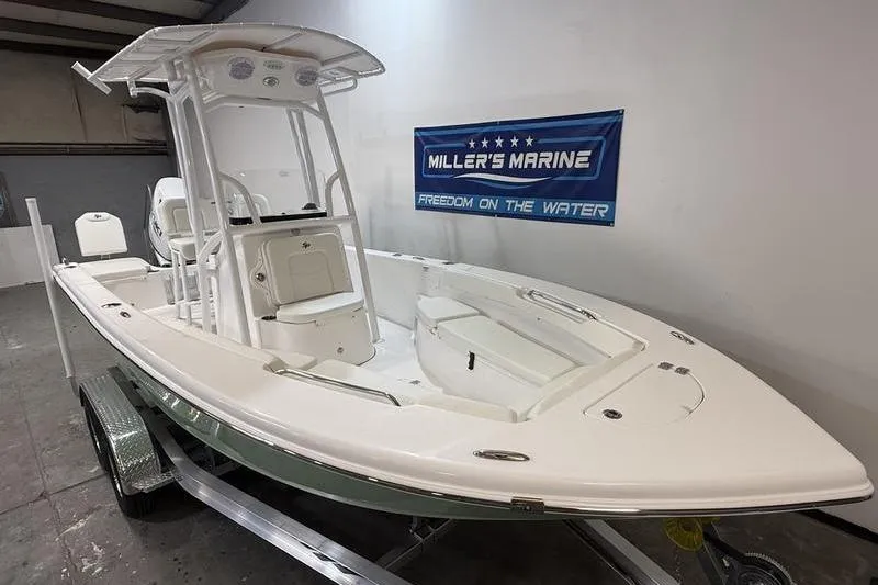 Slide: The Image of 2026 Sea Pro 202 Center Console boat displayed at Miller's Marine showroom. - 2