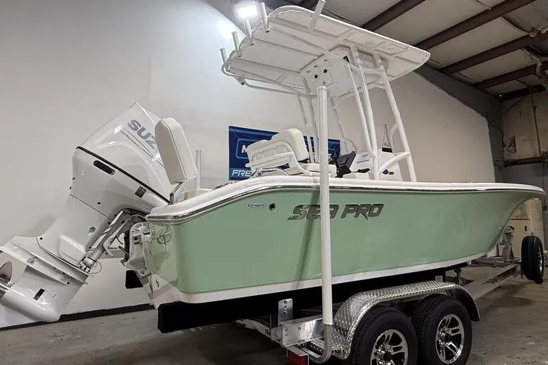 Slide: The Image of 2026 Sea Pro 202 Center Console boat on trailer in indoor storage. - 3