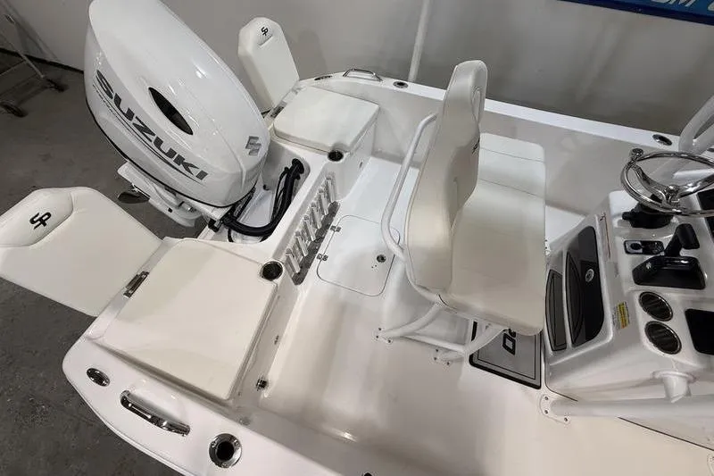 Slide: The Image of 2026 Sea Pro 202 Center Console boat interior with Suzuki engine, white seating, and control panel. - 6