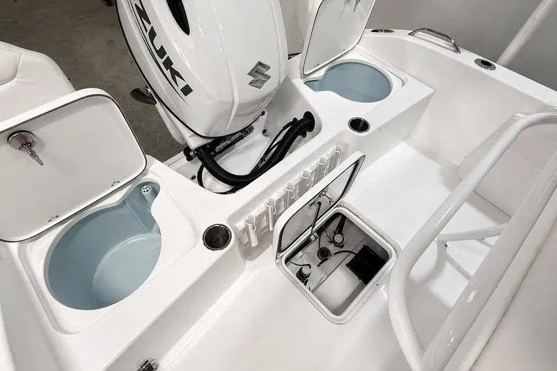 Slide: The Image of 2026 Sea Pro 202 Center Console boat interior with Suzuki engine and storage compartments. - 7