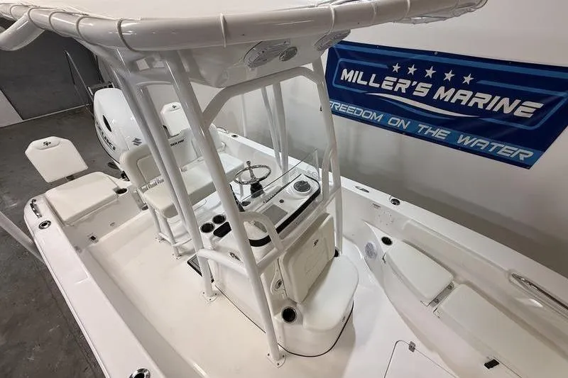 Slide: The Image of 2026 Sea Pro 202 Center Console boat at Miller's Marine showroom. - 8