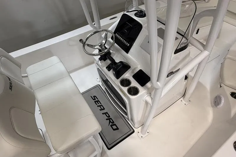 Slide: The Image of 2026 Sea Pro 202 Center Console boat interior with steering wheel and seating. - 9