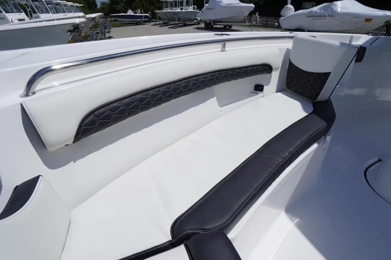 Slide: The Image of 2026 Tidewater 232 LXF boat interior with white and black cushioned seating. - 10