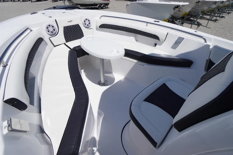 Slide: The Image of Luxurious seating area on 2026 Tidewater 232 LXF boat with modern design and table. - 14