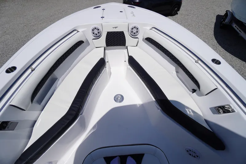 Slide: The Image of 2026 Tidewater 232 LXF boat interior with cushioned seating and speakers. - 16