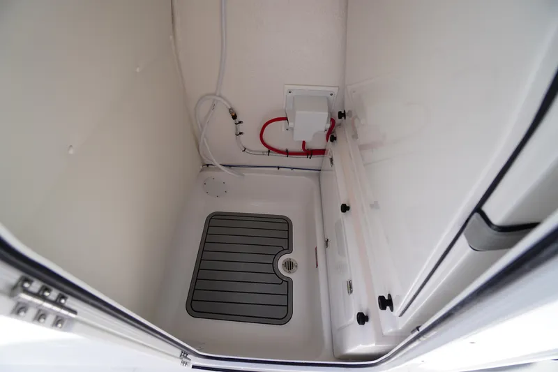 Slide: The Image of Interior view of 2026 Tidewater 232 LXF boat compartment with drainage system. - 22