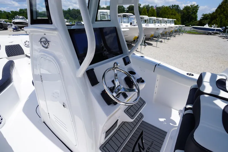 Slide: The Image of 2026 Tidewater 232 LXF boat interior with modern steering console and seating. - 25