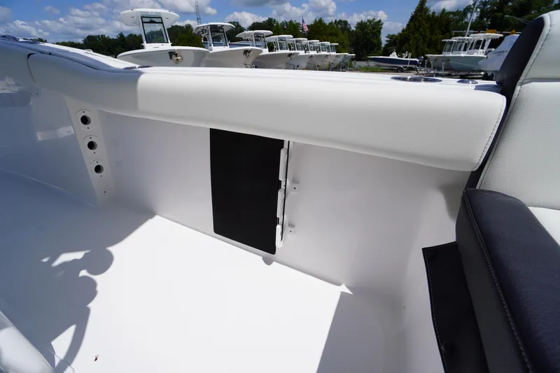 Slide: The Image of 2026 Tidewater 232 LXF boat interior with white seating and storage compartment. - 42