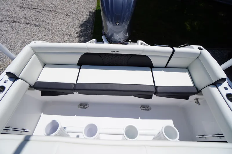 Slide: The Image of 2026 Tidewater 232 LXF boat interior with cushioned seating and rod holders. - 45