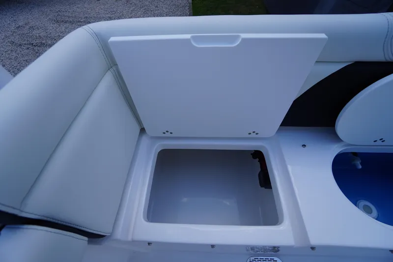 Slide: The Image of 2026 Tidewater 232 LXF boat storage compartment with open lid, showcasing interior space. - 51