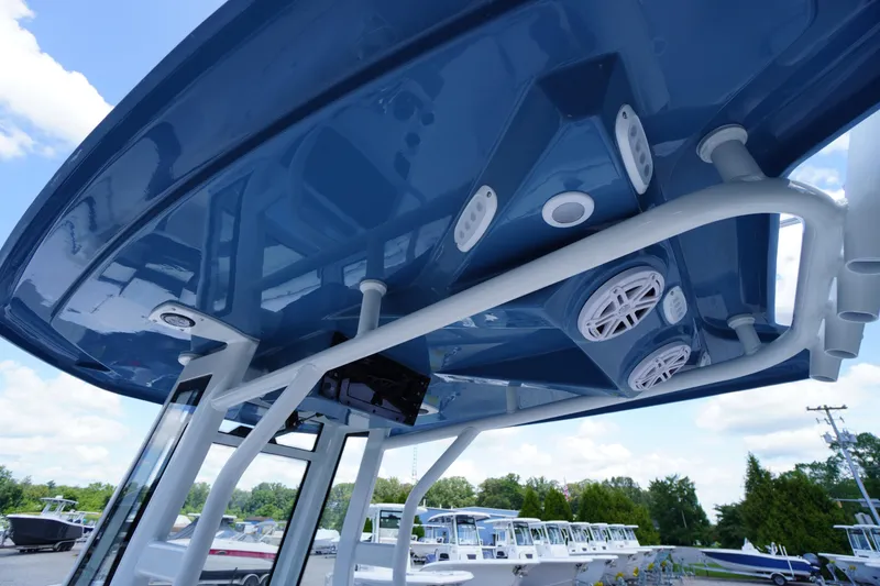 Slide: The Image of 2026 Tidewater 232 LXF boat with blue T-top and integrated speakers. - 62