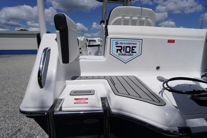 Slide: The Image of 2026 Tidewater 232 LXF boat with Seakeeper Ride stabilization, docked under a blue sky. - 69