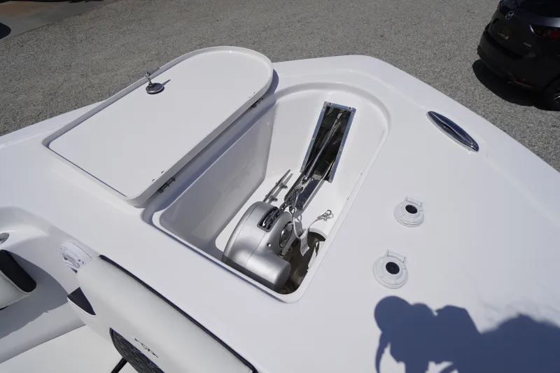 Slide: The Image of 2026 Tidewater 232 LXF boat anchor compartment with open hatch, showcasing storage features. - 7