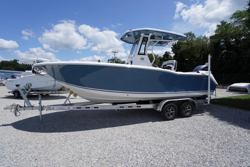 Slide: The Image of 2026 Tidewater 232 LXF boat on trailer under blue sky. - 80